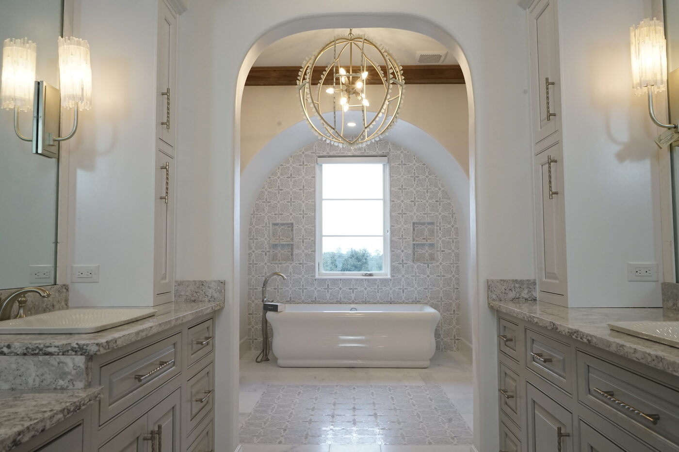Master bath with matching vanity tops either side of the tub