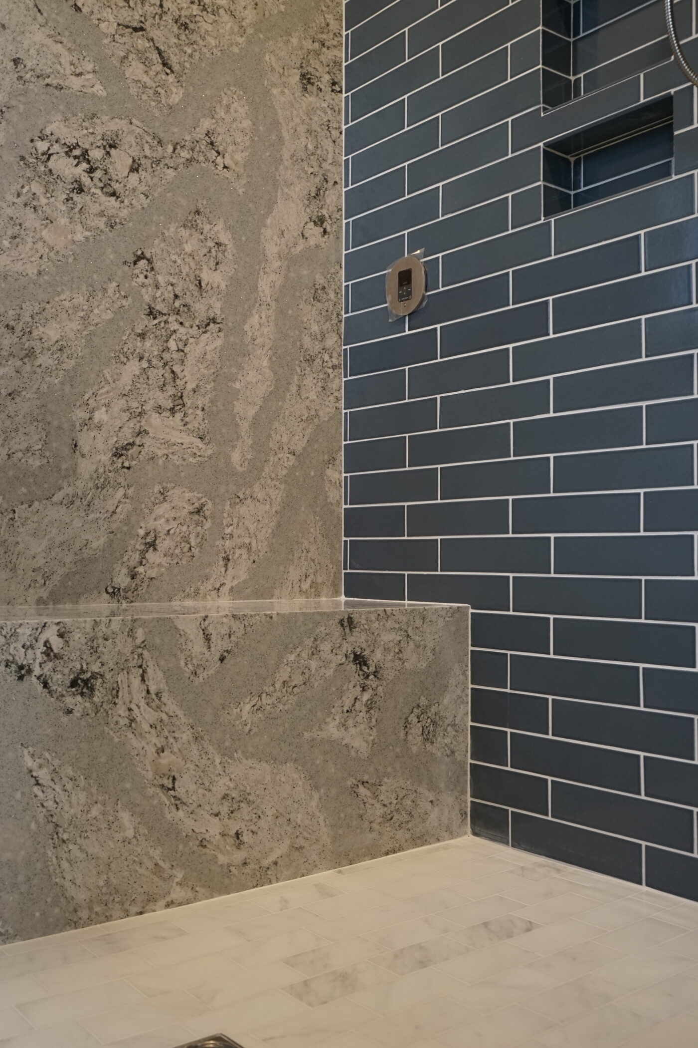 Shower wall and bench cut from a single slab