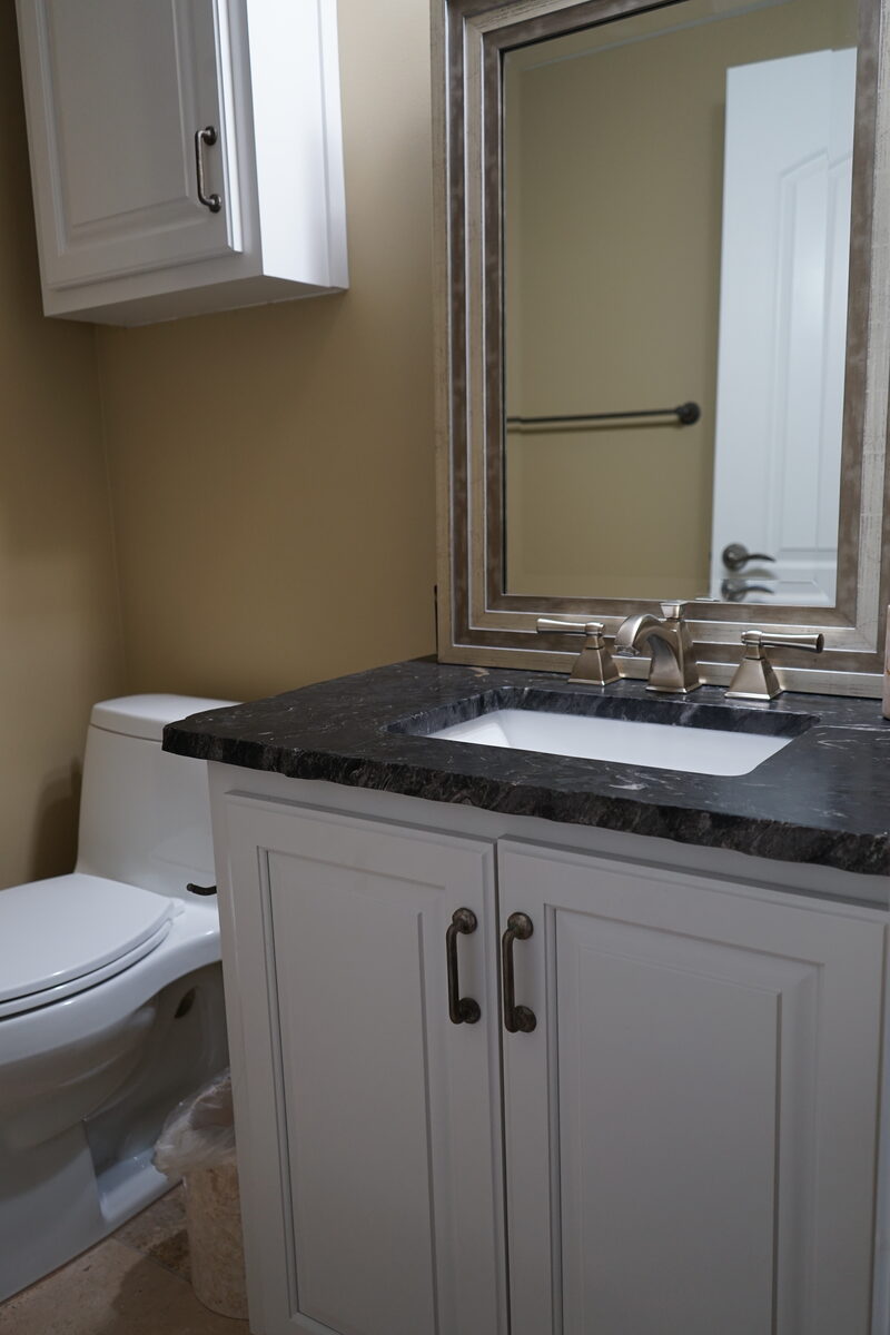 Guest bath vanity with a dark stone top