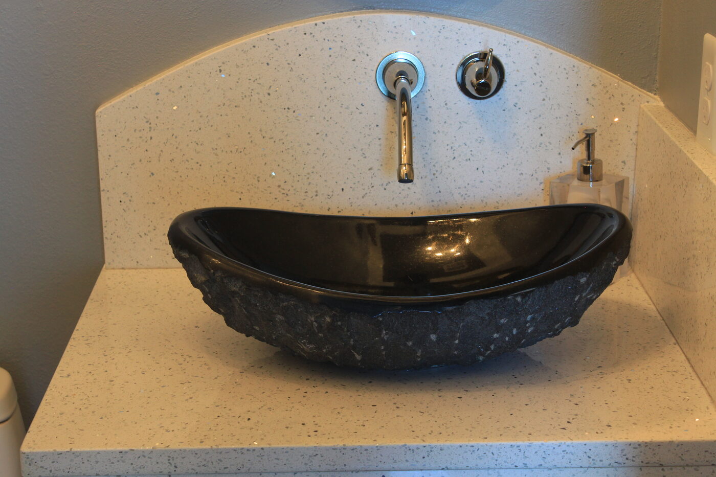 Carved stone bowl set on a quartz deck