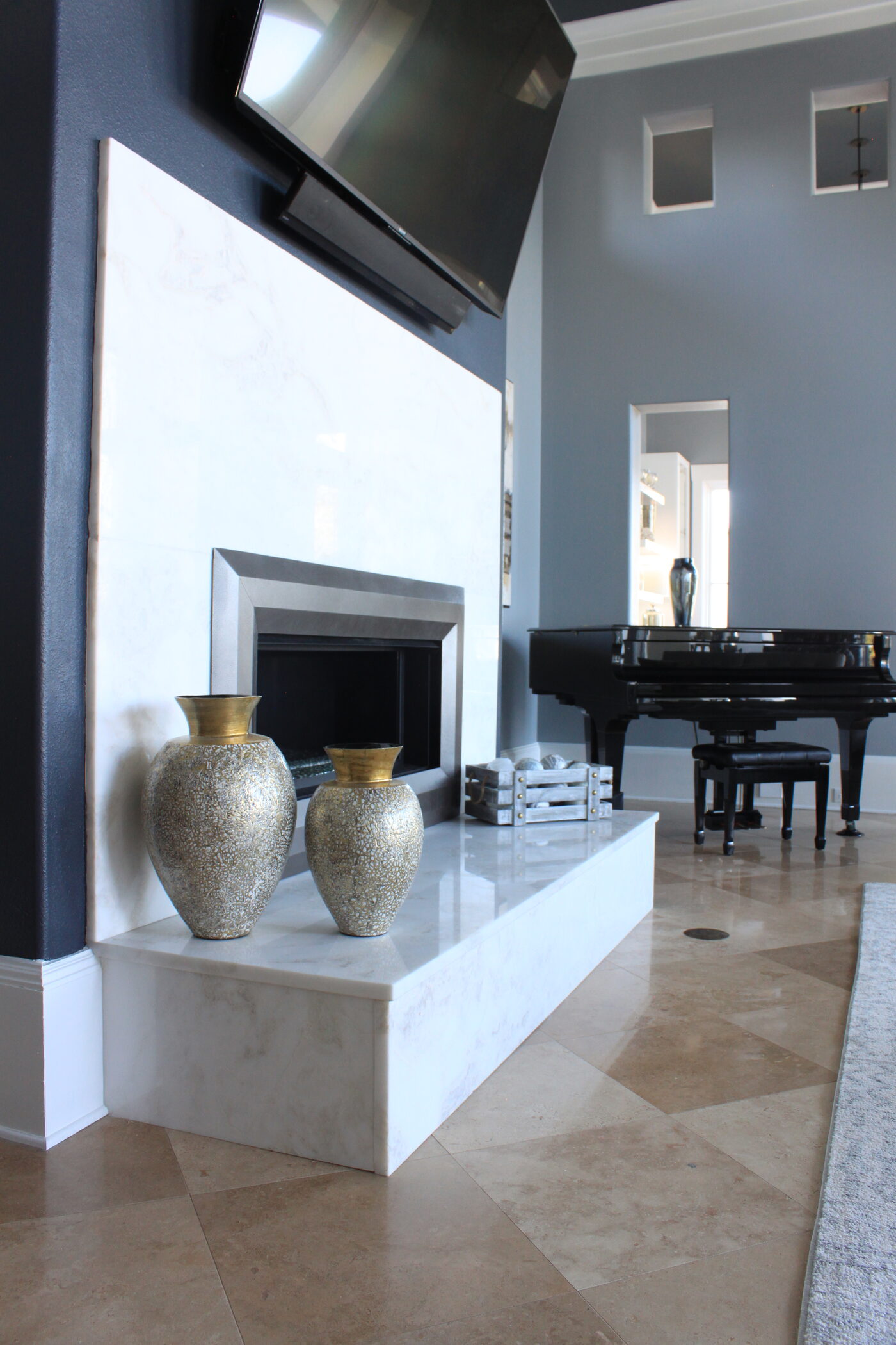Marble fireplace surround and full stone wall by Island Granite